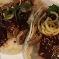 Cochinita Pibil · Yucatan-style pulled pork, cooked for over four hours topped with habanero salsa and pickled...