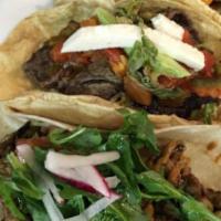 Arabe · Grilled, Puebla-style Lebanese influenced taco with marinated pork topped with a fresh homem...
