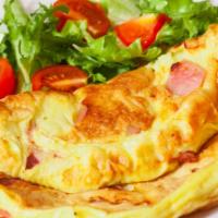 Classic Three Egg Omelet With Cheese & Ham · Fluffy, buttery, three egg omelet topped with melty Jack-Cheddar mix and sliced ham. Served ...