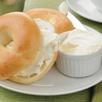 Plain Bagel · Freshly baked plain bagel, toasted with a generous smear of butter. Add on a topping or subs...