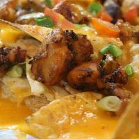 Chicken Nachos · Classic chicken nachos with melted cheese, pico de gallo, beans, and your choice of toppings.
