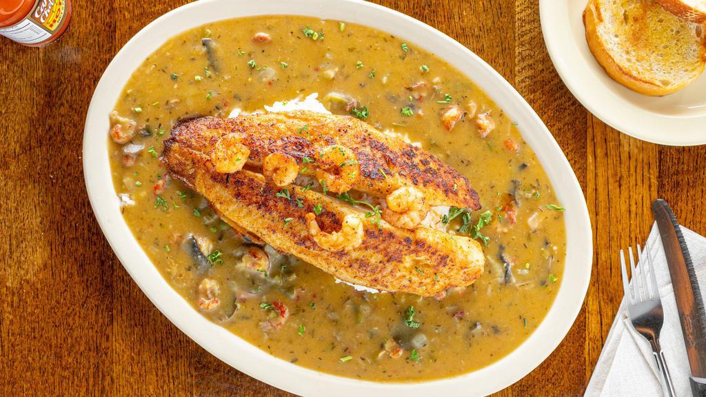Fisherman’S Catch · Blackened or Fried catfish fillet served on a bed of white rice topped with shrimp and crawfish etouffeè. Served with two garlic bread slices.