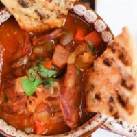 Callos Caseros · Braised beef tripe, Spanish chorizo, pinto beans, lightly spicy tomato sauce and toast points.
