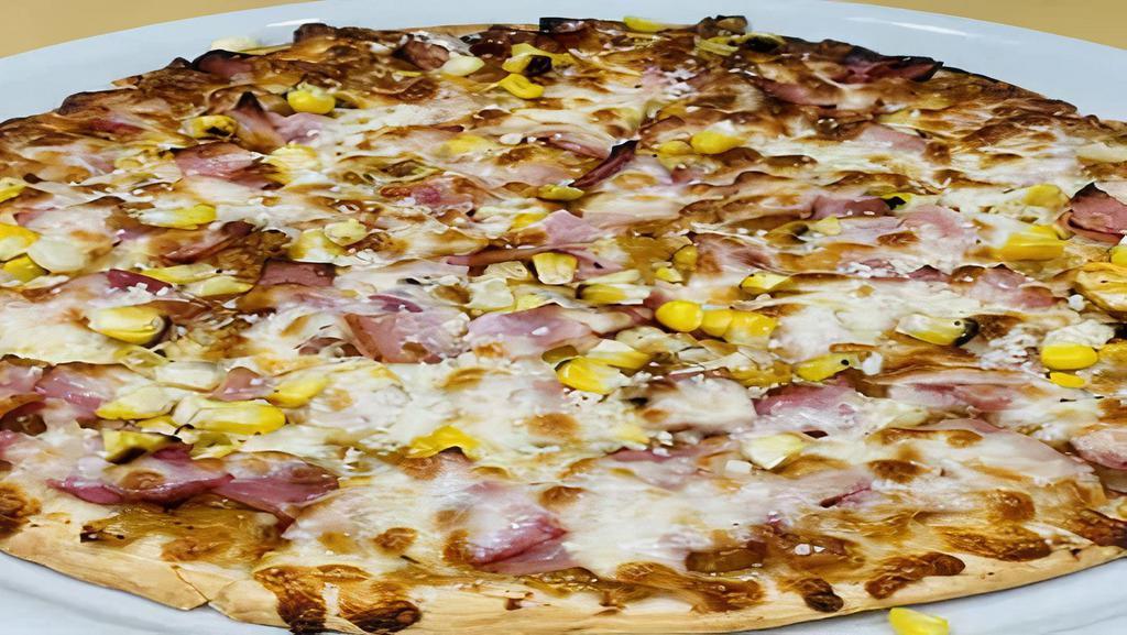 Hawaiian Pizza · Grilled thin crust, caramelized pineapple, roasted corn, sliced ham, parmesan and mozzarella cheese.
