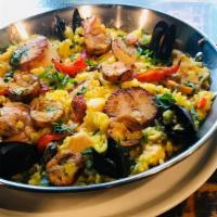 Paella Valenciana · Shrimp, scallops, mussels, calamari, Spanish chorizo, chicken tenderloins, roasted red peppe...