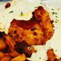Chicken Parmesan · Classic Italian breaded and fried chicken tender scallopini, served over the bed of fettucci...