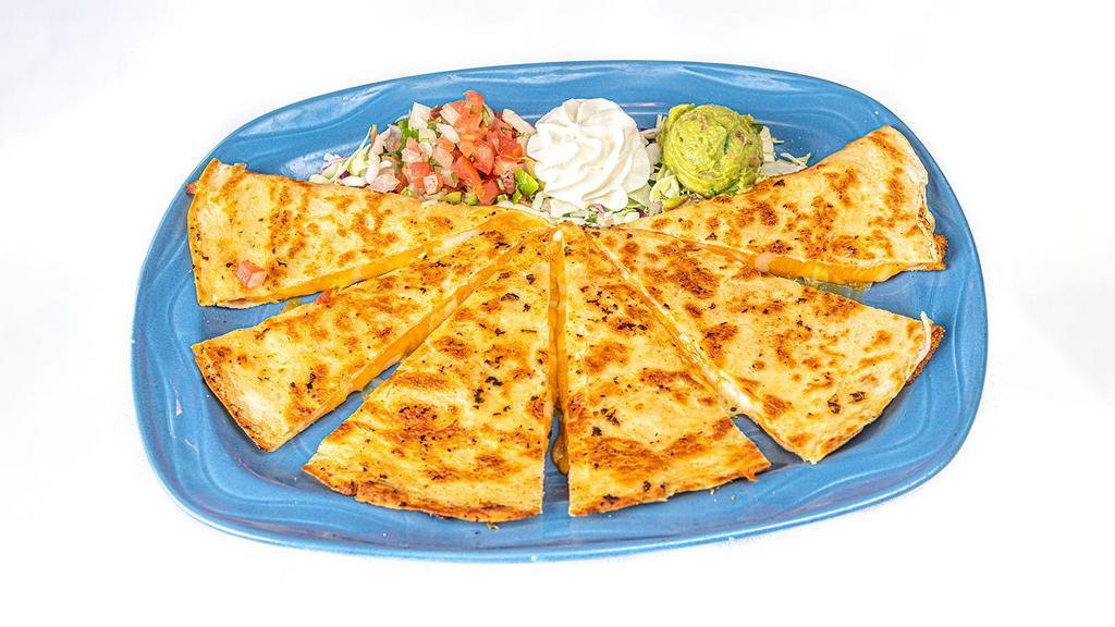 Quesadilla Muy Bueno · Crispy homemade flour tortilla filled with melted Monterey Jack, Cheddar and Mozzarella cheese. Garnished with guacamole, sour cream and Pico de Gallo.