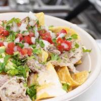 Nachos · Fresh chips served with Queso and choice of protein with lettuce, cheese, sour cream and pic...