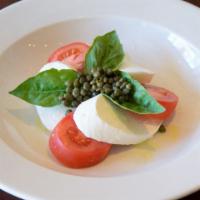 Caprese Salad · Fresh buffalo Mozzarella, roma tomatoes, fresh basil, capers & pesto vinaigrette.