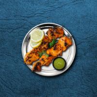 Charred Chicken Tikka · Succulent morsels of chicken, marinated in tandoori masala and yogurt, cooked in an Indian c...