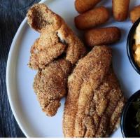 Delta Catfish Platter · Two fillets, hand-breaded & crispy-fried, a side of tartar sauce and two Southern Sides.