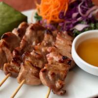 Street Style Grilled Pork · Skewers of marinated pork served with sticky rice and savory sweet dipping sauce.