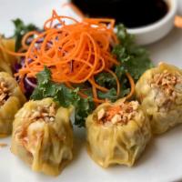 Kanom Jeeb · Steamed homemade Thai dumplings with minced pork and shrimp filling. Comes with savory soy s...