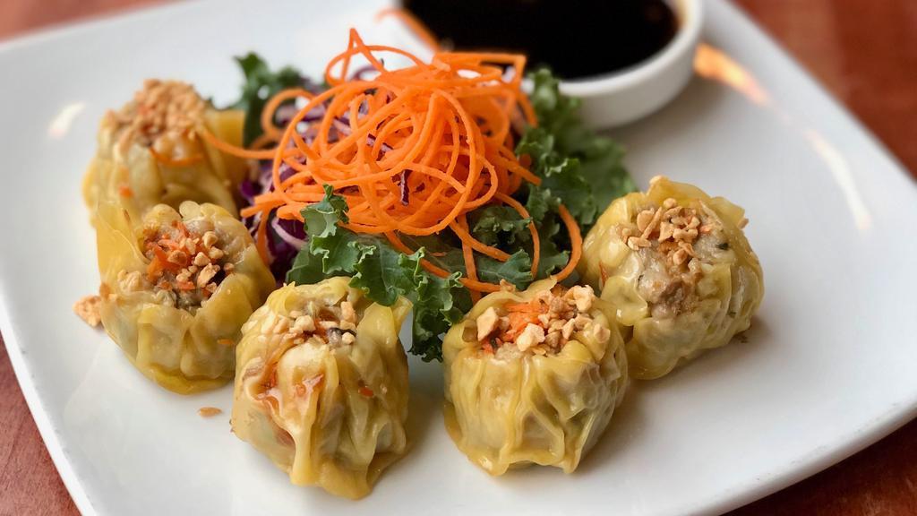 Kanom Jeeb · Steamed homemade Thai dumplings with minced pork and shrimp filling. Comes with savory soy sauce.