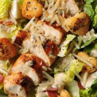 Grilled Chicken Caesar Salad · Grilled boneless breast of chicken served on a bed of romaine lettuce with croutons, Parmesa...