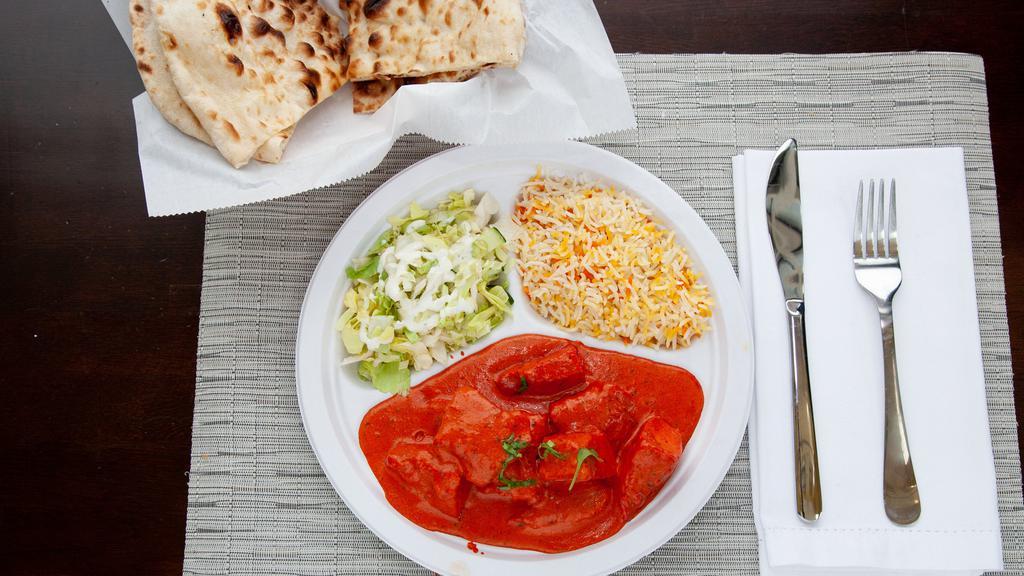 Chicken Tikka Masala · By far one of our most popular dishes. A tomato and light spices sauce, with a hint of cream and chunks of chicken (white meat). Served with rice, salad and naan.