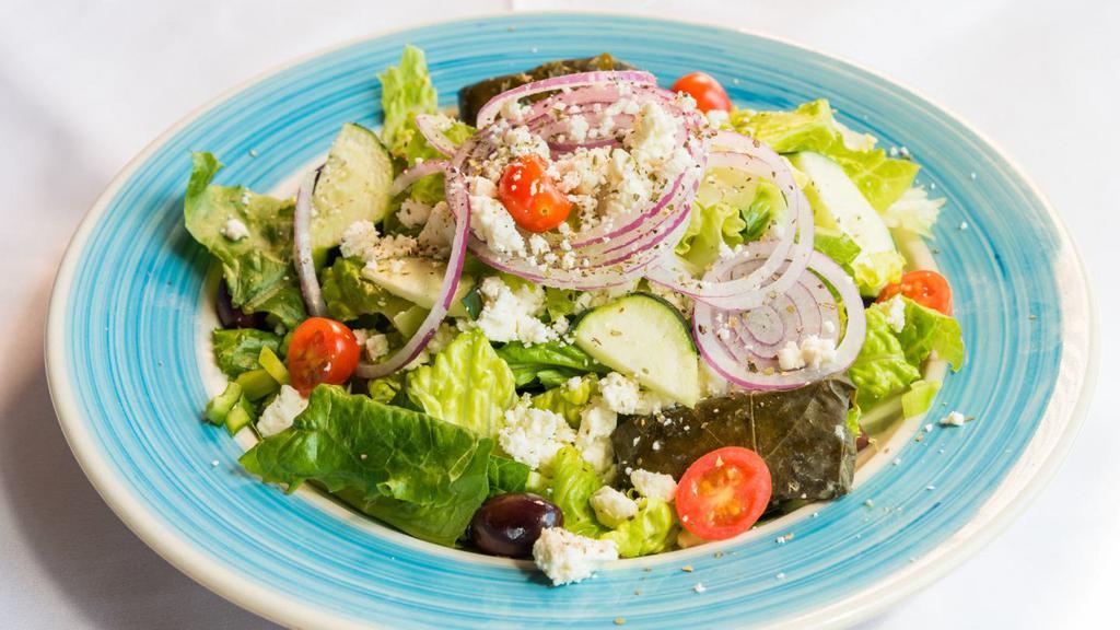 Greek Salad · Tomatoes, cucumbers, onions, kalamata olives, peppers, feta cheese over romaine lettuce with greek dressing (anchovies optional)