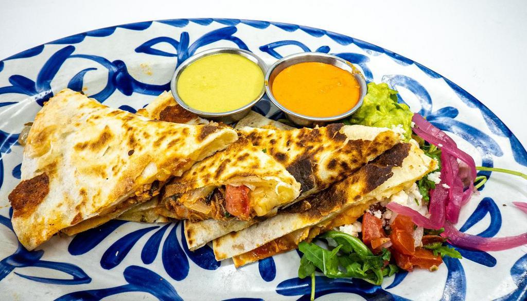 Quesadilla Pollo · grilled flour tortillas with house blend of cheeses, onions, tomatoes and side of rojo and verde jalapeño salsas