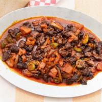 Awaze Tibs · A mildly spicy tibs cooked with tomatoes, jalapeño peppers, red onions and awaze.