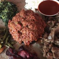 Kitfo · Minced raw beef marinated in mitmita (a chili powder-based spice blend) and niter kibbeh (a ...