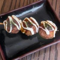 Takoyaki (Octopus Donuts) · Octopus filled savory donuts sauced with takoyaki sauce, Japanese mayo and seaweed flakes. T...
