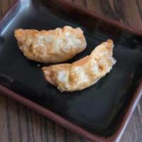 Fried Gyoza (1 Piece) · Fried pork filled dumpling.