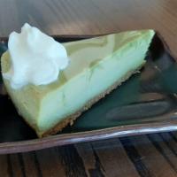 Matcha Green Tea Cheesecake · Slice of matcha green tea flavored cheesecake.