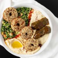 Vegetarian Special Bowl · Our signature bowl served with a base of hummus, and babaganoush. Topped with two stuffed gr...
