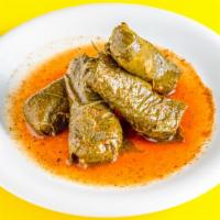 Stuffed Grape Leaves · Family recipe! Hand-rolled grape leaves stuffed with seasoned rice, cooked in pomegranate mo...