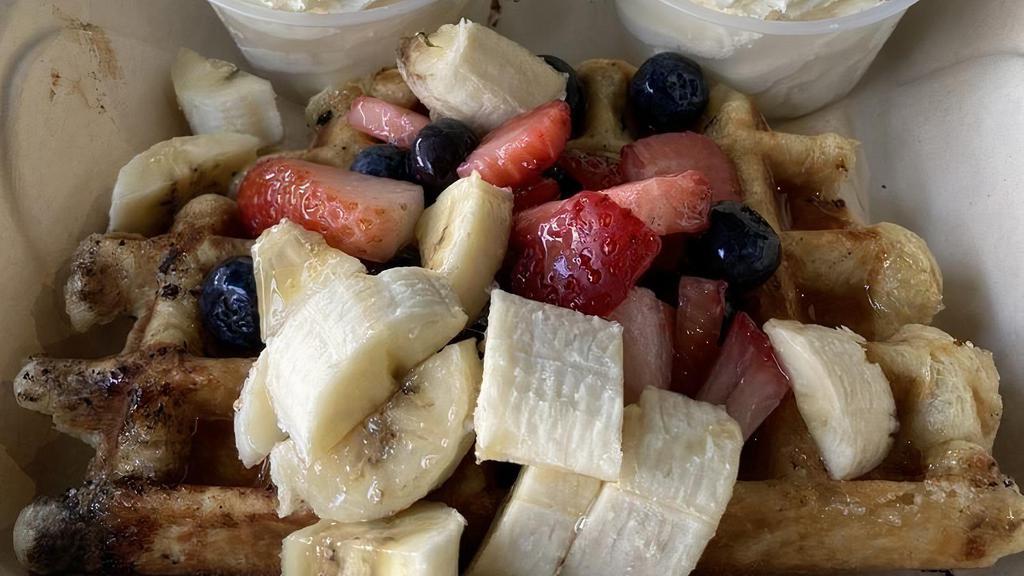 Fresh & Fruity Waffle (Sweet) · Dough-based, peart sugar glazed, authentic belgian liege. Waffle topped with fresh strawberries, blueberries, bananas, homemade whipped cream, and drizzled with maple syrup.