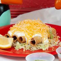 Rolled Tacos (4) · Served with guacamole, sour cream and cheese.