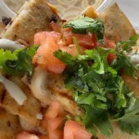 Laura'S Pollo Loco Quesadilla · The unassuming quesadilla that fits the budget and takes you to a happy place. Made with shr...