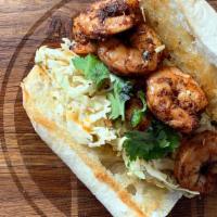 Blackened Shrimp Po'Boy · 6 medium blackened shrimp served on butter toasted New Orleans Gambinos French Bread atop a ...