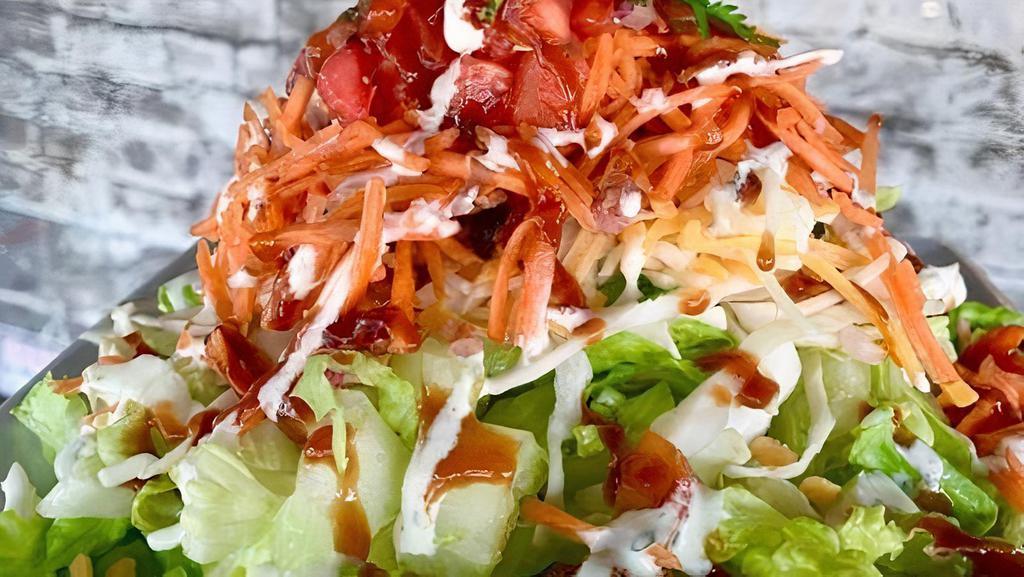 Southwest Salad · Romaine lettuce, shredded cabbage, cheese, taco chicken, pico, cilantro, Ranch and BBQ drizzle.