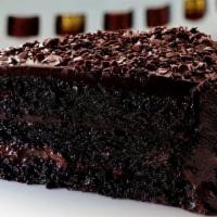 Chocolate Cake · Moist chocolate cake filled with dark chocolate frosting and decorated with chocolate flakes.