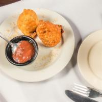 Vegetable Samosa · Deep fried patties stuffed with spices, potatoes, and peas. Served with tamarind sauce.