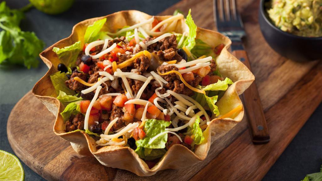 Taco Salad · Chicken or beef fajita served with fresh lettuce, tomatoes, american cheese, guacamole, and sour cream.