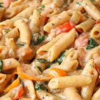 Rasta Pasta · Penne pasta in a creamy coconut basil sauce with chicken