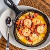 Shrimp & Grits · Jumbo shrimp sauteed in butter with bacon, tomatoes, capers and served with cheddar cheese g...