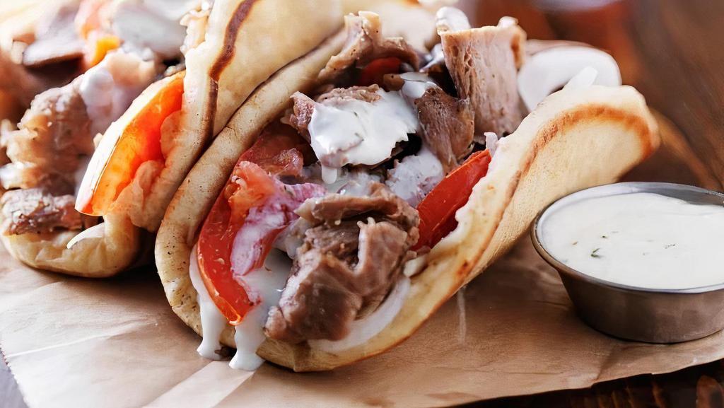 Gyro Wrap · Greek pita, gyro meat, tzatziki sauce, tomato and onions.