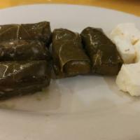 Grape Leaves (5 Pieces) · Gluten-free and vegan. Grape leaves stuffed with rice, onions, lemon juice and parsley cooke...