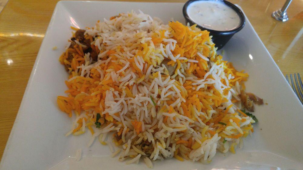 Chicken Biryani · Chicken cooked into a spicy sauce and layered in basmati rice then baked with a blend of decedent Pakistani spices.