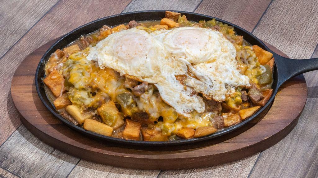 Chile Con Carne Skillet · Home fried potatoes topped with red or green chile con carne, 2 eggs & cheese.