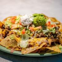 Nachos · Tostada chips topped with beans, ground beef, cheese, lettuce, tomato, jalapeños, sour cream...