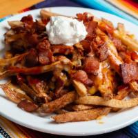 Loaded Fries · Home cut fries topped with your choice of red or green chile, bacon, cheese & a dollop of so...