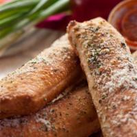 Breadwicks · Three breadsticks topped with garlic herb butter and parmesan cheese, served with marinara s...