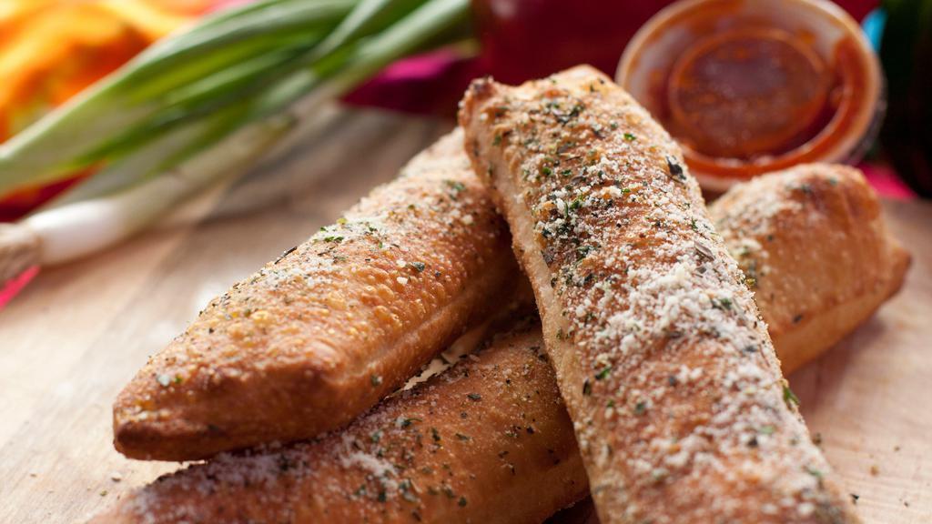 Breadwicks · Three breadsticks topped with garlic herb butter and parmesan cheese, served with marinara sauce.