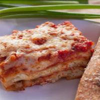 Baked Lasagna · Layers of pasta filled with ricotta cheese, sausage and beef. Covered with marinara sauce, m...