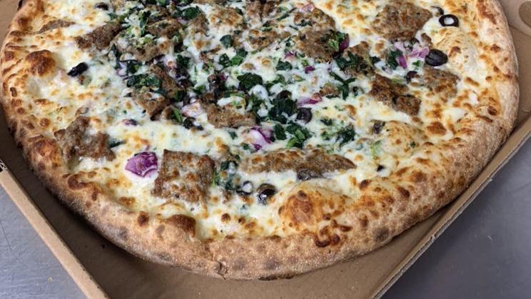 Greek Pizza · Gyro meat, tzatziki sauce, spinach, red onions, black olives, tomatoes, feta cheese with fresh natural cheese.