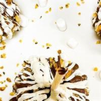 Peanut Butter Bomb Caramel Apple · A Granny Smith apple covered in fresh caramel, rolled in a mixture of peanut butter, white c...